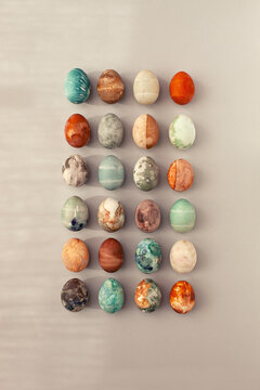 Directly above shot of twenty-four colorful Easter eggs with patterns