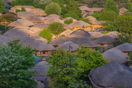 Traditional thatched roof houses at Naganeupseong Folk Village in Suncheon, South Korea, beautiful sunrise landscape view.
