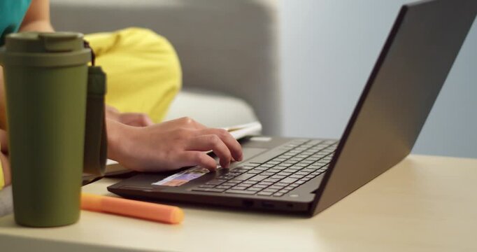 A focused individual typing a laptop in a cozy home environment showcasing remote work.