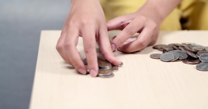 A detailed view of hands skillfully sorting coins for efficient counting.