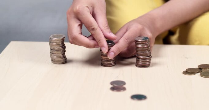 A focused individual counting coins illustrating patience financial awareness and organization.