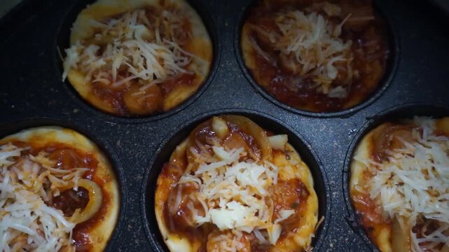 Lots of Mini Pizzas, fresh homemade Tawa pizzas, pan pizzas cooked with mozzarella cheese, parsley, cherry tomatoes and basil on a hot teflon.