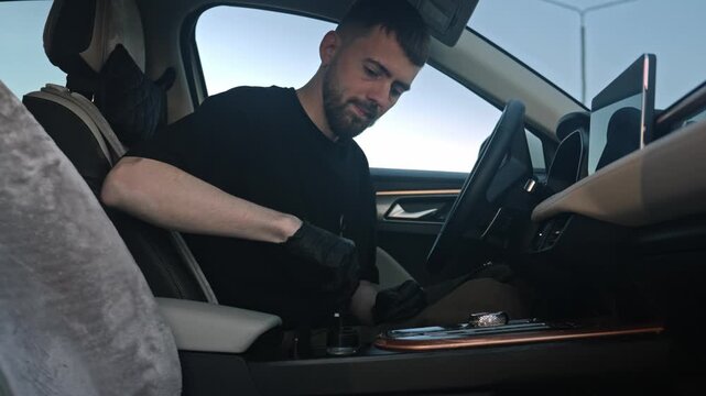 Caucasian Man Cleaning Leather Trim. Gentleman Meticulously Cleaning Leather Parts Inside Vehicle