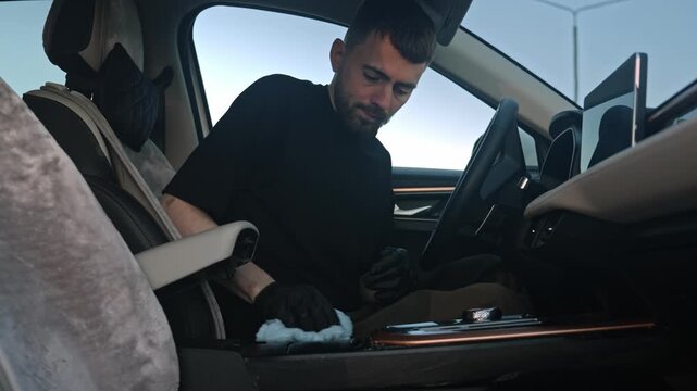 Caucasian Man Buffing Leather Console For Shine And Finish, Gloved Hands, Delicate Circular Strokes