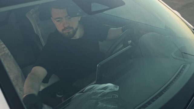 Professional car interior cleaning with special chemicals and tools. A man cleans a car interior