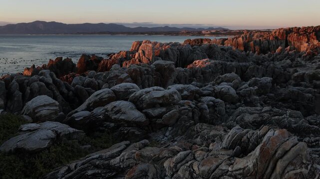 rocky coastline of DeKelders, Gansbaai, South Africa at sunset