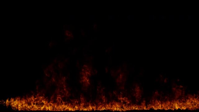 Realistic ground fire burning with intense flames and sparks on a black background.