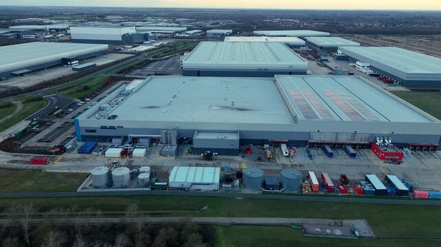 Drone view of golden hour sunlight over a sprawling logistics park in Peterborough.