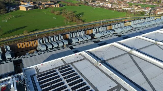 Drone view of massive industrial cooling arrays and HVAC systems for AI server halls.