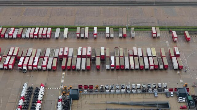 Aerial view of semi trucks and HGVs lined up at a major distribution center in the UK.