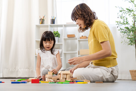mother, daughter, education, STEM learning, intelligence development parent guiding child using wooden toy block, supporting intelligence quotient and emotional quotient through interactive knowledge