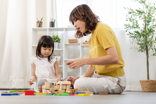 Family bonding relationship, education, homeschool mom and little girl playing wooden toy block, intelligence, problem solving activity, emotional quotient development, happy children play and learn