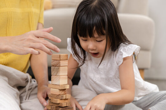 Education, children learning development, play with family, cognitive, problem solving, brain creativity with parent using motor skill stacking toy blocks, emotional quotient and intelligence ability