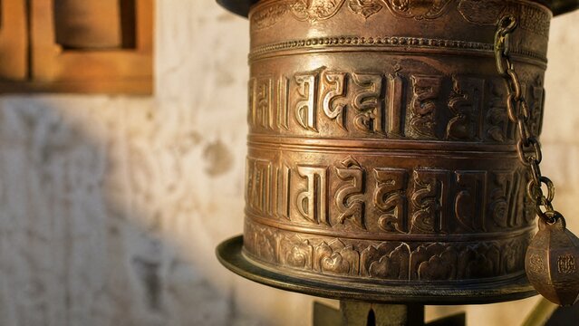 tibetan. An ancient Tibetan prayer wheel with intricate engravings in sunlight. event programs, museum guides, designed for cultural heritage projects and event programs, preserves heritage.