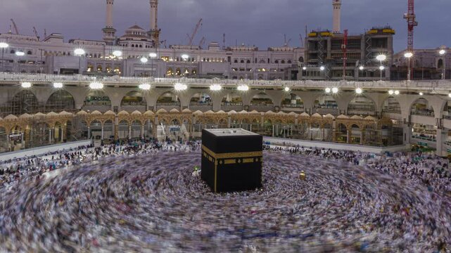 Beautiful Sunrise Time Lapse of Masjid al-Haram in Mecca Saudi Arabia, Scenic Zoom In View of Kaaba in the Courtyard with Crowds of Muslim Pilgrims Praying during Holy Morning Dawn Sky. Zoom in motion