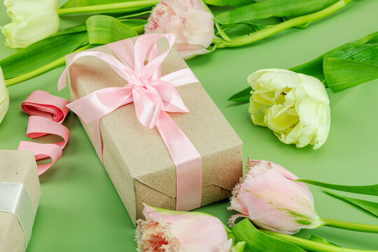 Happy Mothers Day concept. Gift boxes wrapped in craft paper and ribbons, handmade crocheted hearts