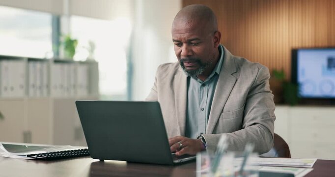 Black man, document and laptop in office for project management, report or email at PR agency. Business person, typing and mature public relations manager with tech with paperwork or communication