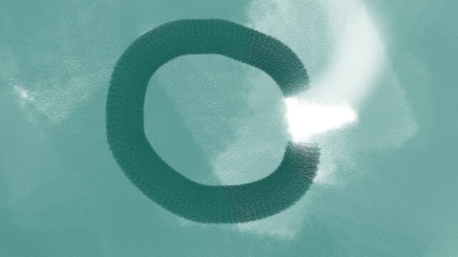 A round green snake or worm or hose spins, emitting smoke or bright gas.