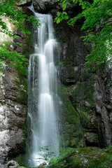 Obraz premium Beautiful Maewoldae Waterfall surrounded by lush green mossy rocks in Cheorwon, South Korea, scenic long exposure landscape.
