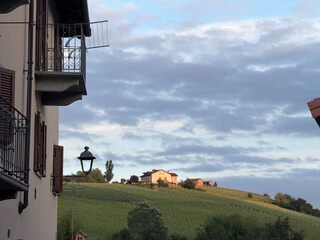 Fototapeta premium View of Italian Vineyard Hills and Traditional Architecture in Barolo