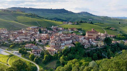 Fototapeta premium Panoramic Aerial Shot of Barolo Village Surrounded by Lush Green Vineyards