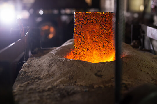 Ferrous metal billet is melted in an induction furnace closeup