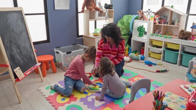 Woman and two girls sit on a colorful foam mat, hands assembling wooden puzzle toy in a childcare building; nurturing joy.