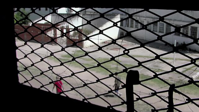 Blurred Prisoners Playing Football Seen From Behind Bars, La Plata, Argentina - 4K