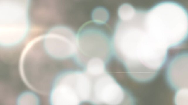 Bright left flare initiating bokeh circles rising, drifting, overlapping, forming luminous backdrop