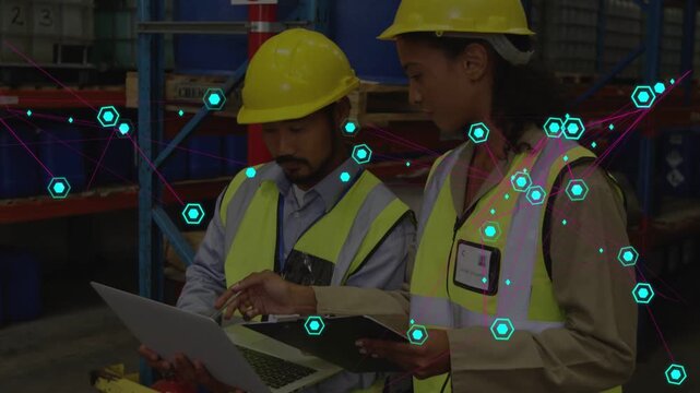 Man tapping laptop and woman noting on clipboard in warehouse, teal overlay guiding review