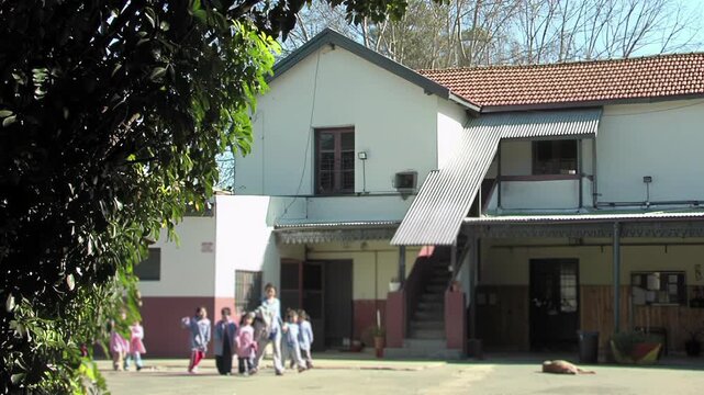 Blurred Argentine Public Kindergarten Kids And Teacher In A Sunny Courtyard - 4K