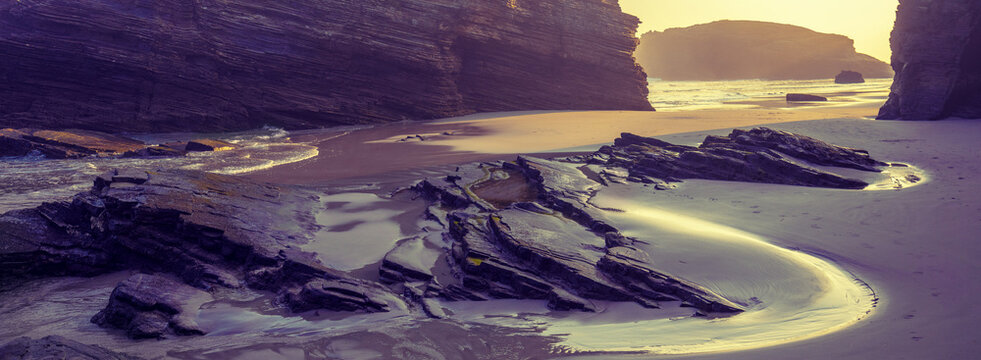 Rocky sea coast at sunrise. Playa de Las Catedrales, Ribadeo, Spain, Europe
