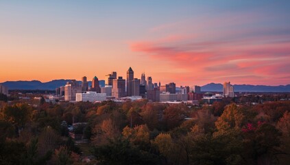Obraz premium A glowing sunset highlights the city skyline with distant mountain views expressing seasonal variation