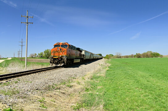 A lone locomotive leads a Burlington Northern Santa Fe grain train along a rural stretch of right-of-way as it passes eastbound through north central Illinois. 