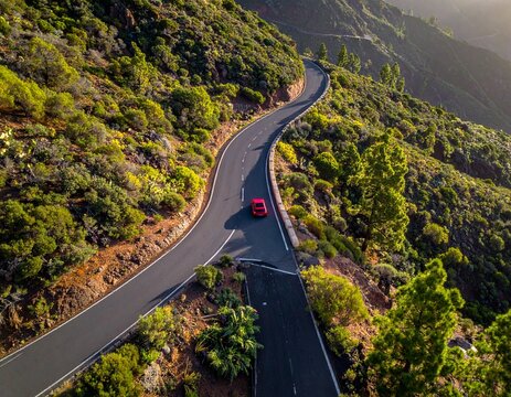 Red car on winding mountain road