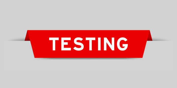 Red color inserted label with word testing on gray background