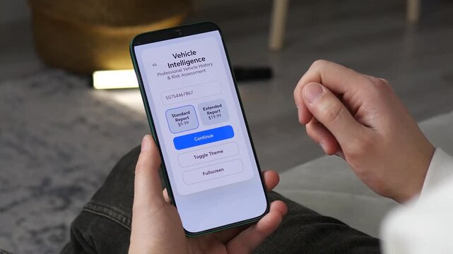 User checking vehicle history and risk assessment on a smartphone. Professional car data app interface. Ideal for automotive services, used car buying guides, and insurance tech content. High-quality