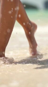 Woman Walking on White Sand Beach with Clear Blue Ocean Water in Tropical Paradise