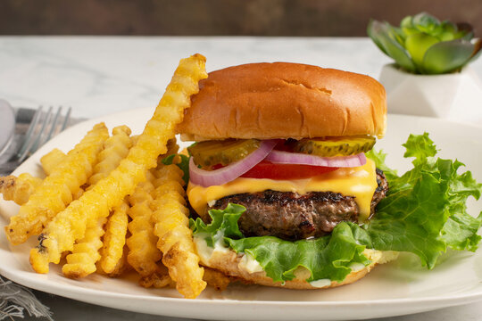 cheese burge  with a side of french fries