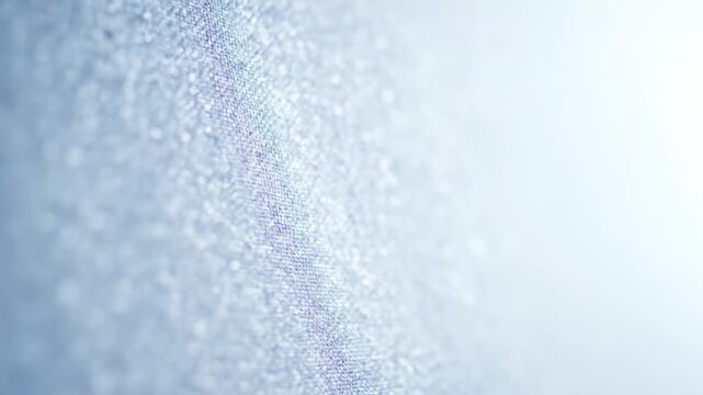 Abstract blue glitter fabric texture with shimmering bokeh light effect for festive background.