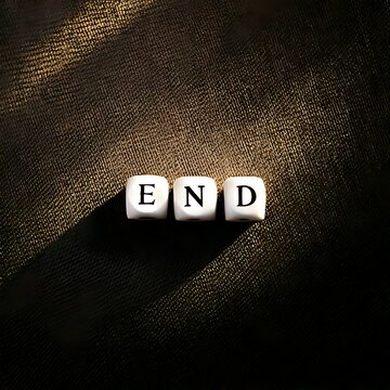 Three white dice with black letters forming the word "END" cast a shadow
