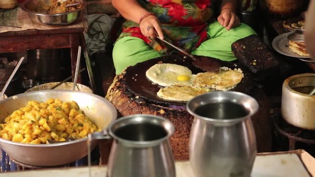Woman Frying Egg While Preparing Traditional Bara Street Food in Bhaktapur Nepal