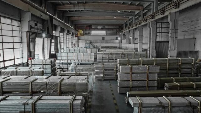 Maintenance Team Reviews Stored Items Amidst Cooltoned Industrial Environment With High Ceilings