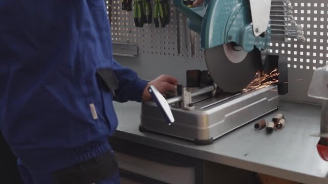 Students work with a cutting machine in a modern training workshop during a metalworking practice.