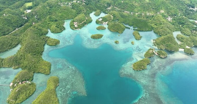 Aerial view of tropical islands in a beautiful bay with turquoise water and lagoon. Sipalay, Negros, Philippines.