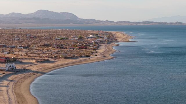 Observe Bahia de Los Angeles in Baja California as the late afternoon sun casts shadows over the sandy beaches and calm waters.