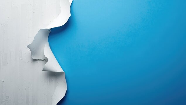 Aged white paint peeling away from blue background with copy space