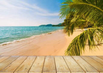 Fototapeta premium Wooden table top on the beach or sea.Party on the beach sunshine time concept.For montage product display or design key visual layout.View of copy space.