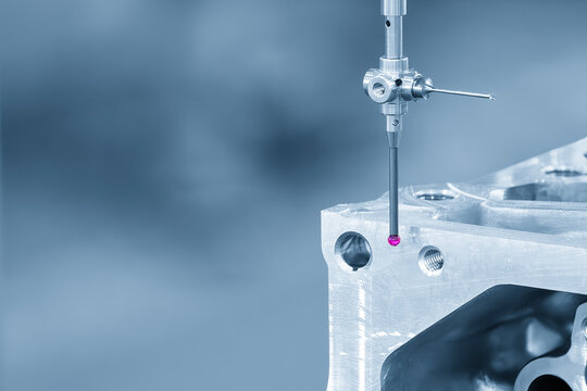 High-precision quality control of aluminum parts using a modular touch probe on a CMM (Coordinate Measuring Machine) in a blue-toned scene.