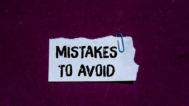 Stop motion animation revealing the phrase 'mistakes to avoid' on a torn paper note against a purple background, representing guidance, learning, and prevention concepts